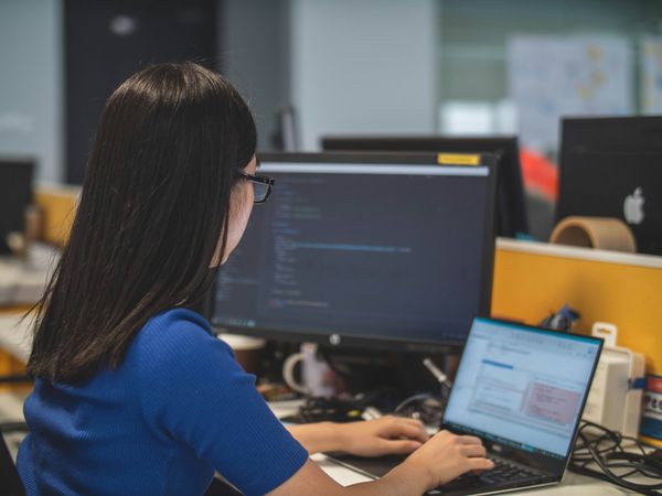 Woman at a desktop computer in an office setting